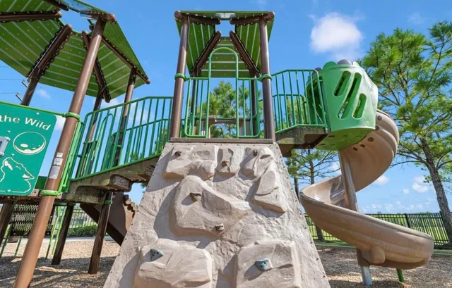 a view of a playground with basketball court