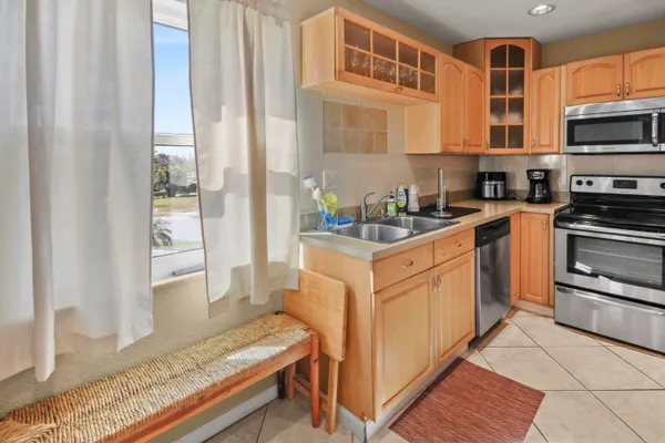 a kitchen with stainless steel appliances granite countertop a refrigerator and a stove top oven