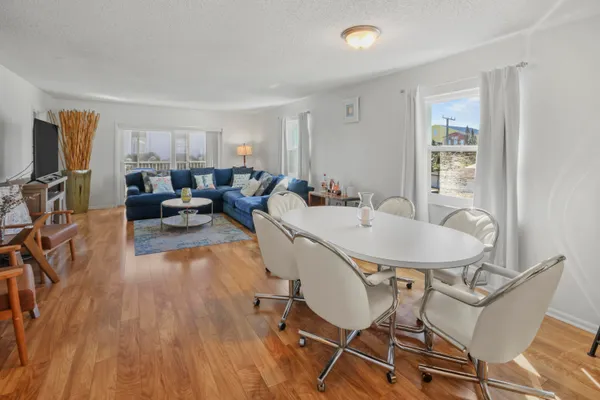 a dining room with furniture and wooden floor
