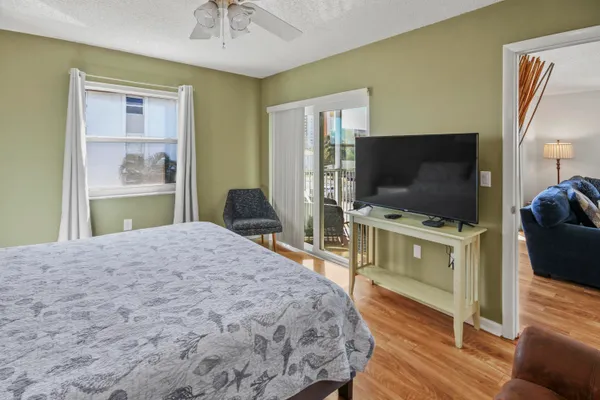 a bedroom with a bed and a flat screen tv