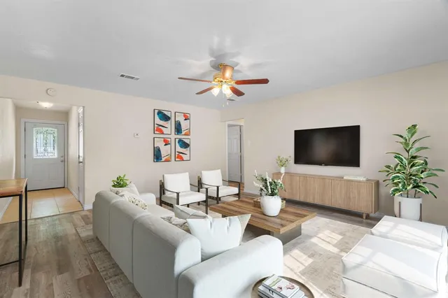 a living room with furniture and a flat screen tv