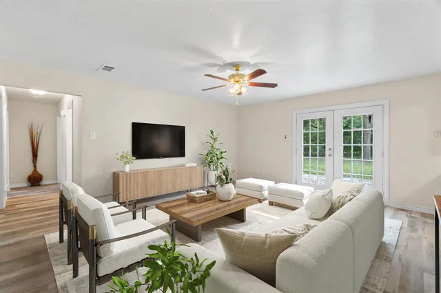 a living room with furniture and a flat screen tv