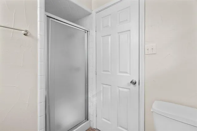 a bathroom with a shower and a toilet