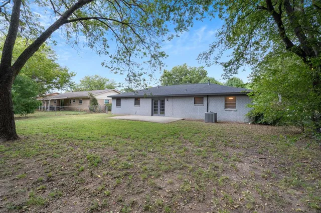 a backyard of a house with plants and trees