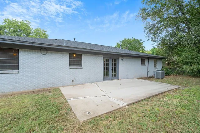 a front view of house with yard and trees