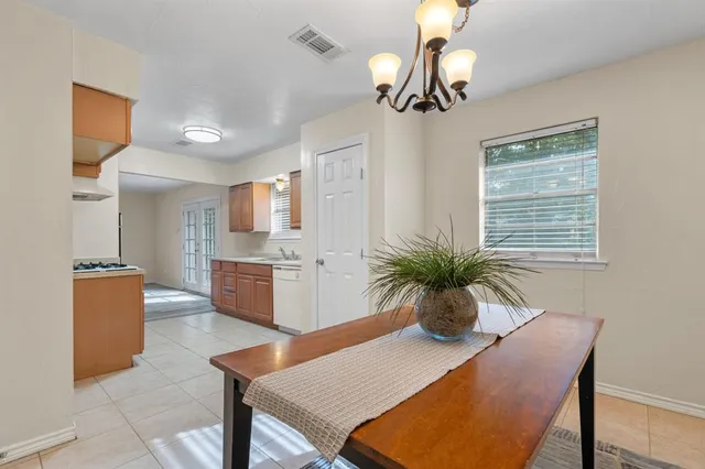 a view of kitchen with kitchen island dining table and chairs