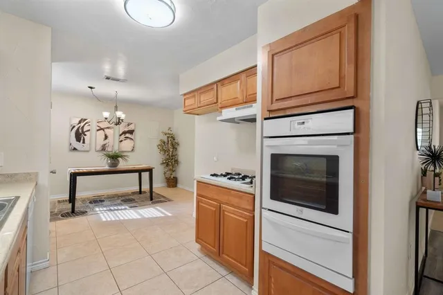 a kitchen with a stove oven and a sink