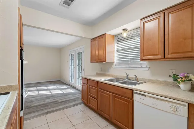 a kitchen with a sink cabinets and utility