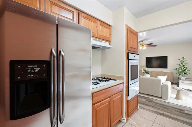 a kitchen with stainless steel appliances a refrigerator a stove and a sink