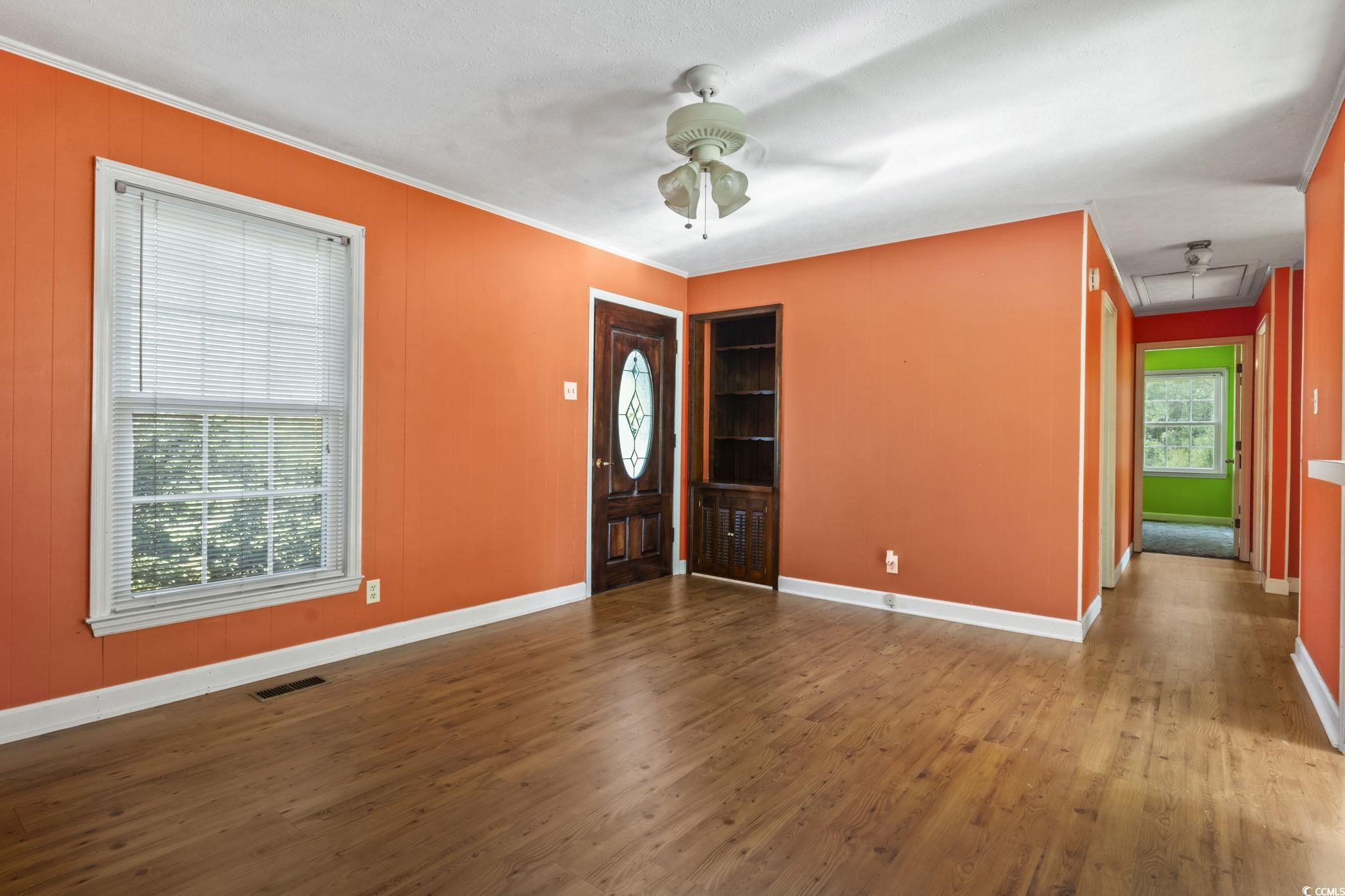 6971 Alfred Road Aynor, SC 29511 - Photo 11 of 37 Entrance foyer with dark wood finished floors, ceiling fan, and ornamental molding
