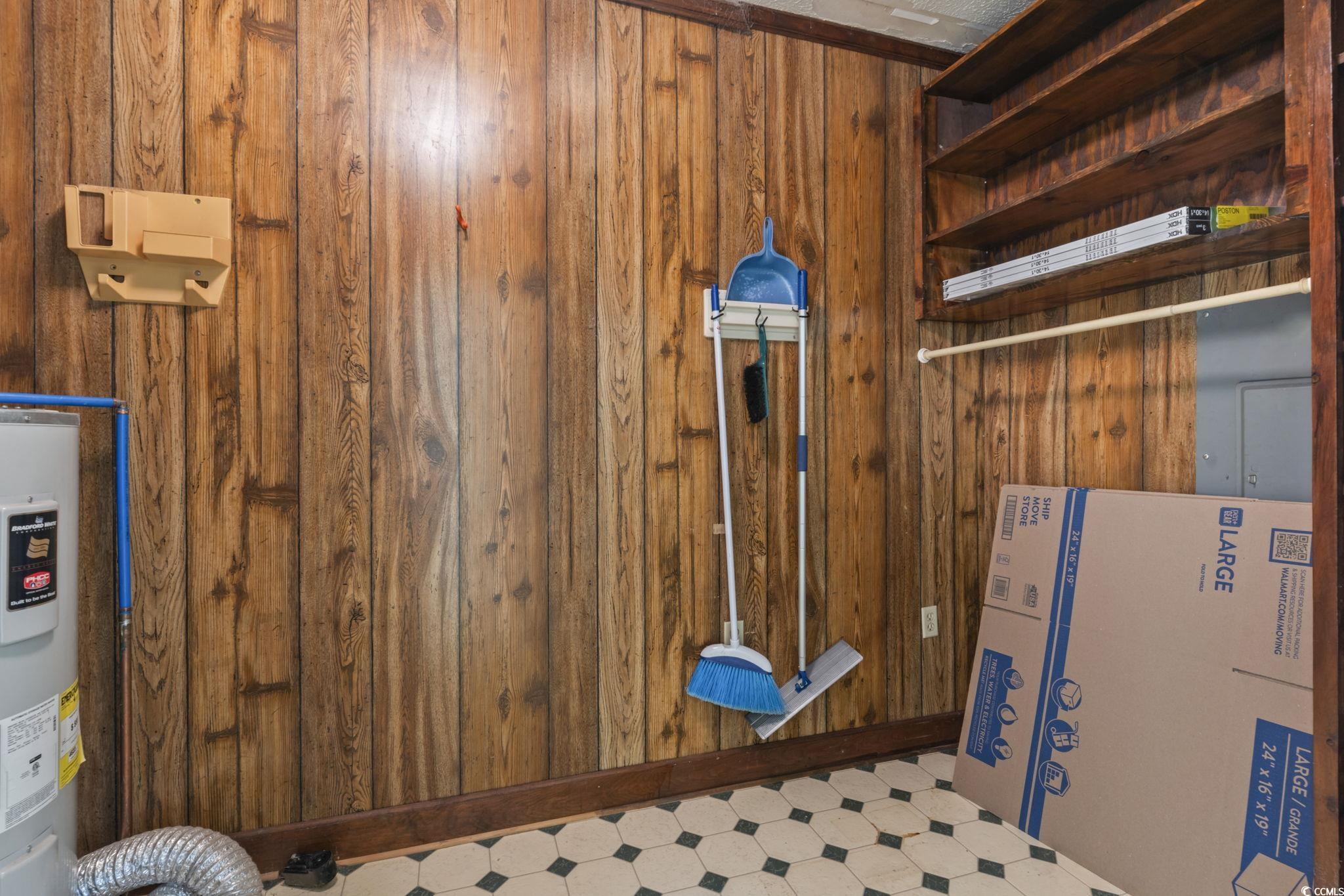 6971 Alfred Road Aynor, SC 29511 - Photo 22 of 37 Detailed view of tile patterned floors, electric water heater, and wood walls