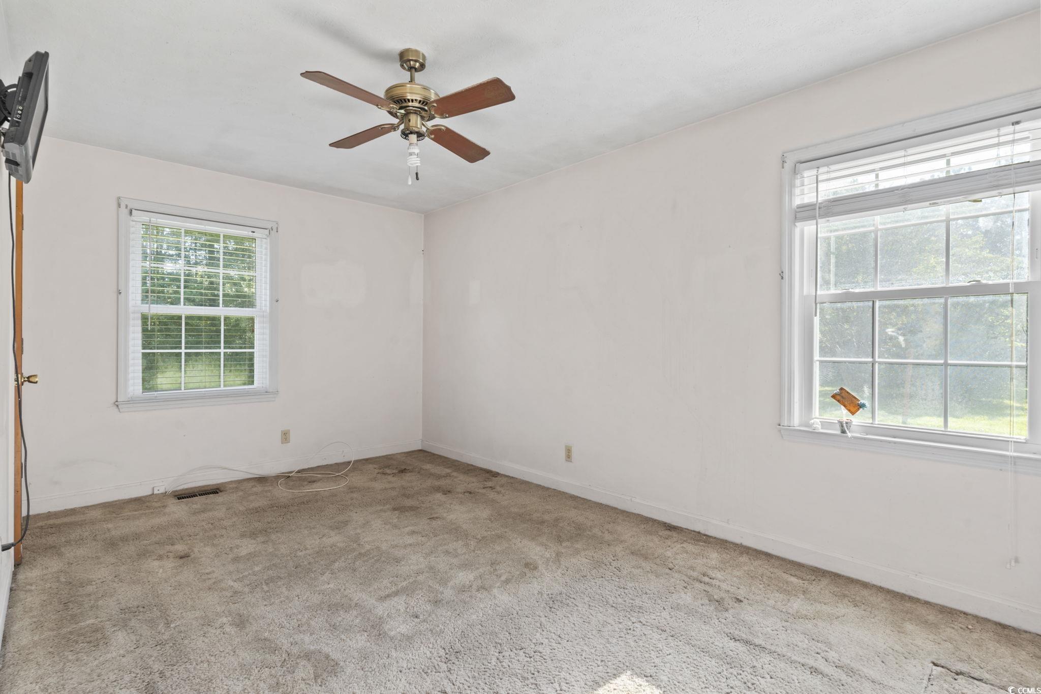 6971 Alfred Road Aynor, SC 29511 - Photo 23 of 37 Carpeted empty room with a ceiling fan and baseboards