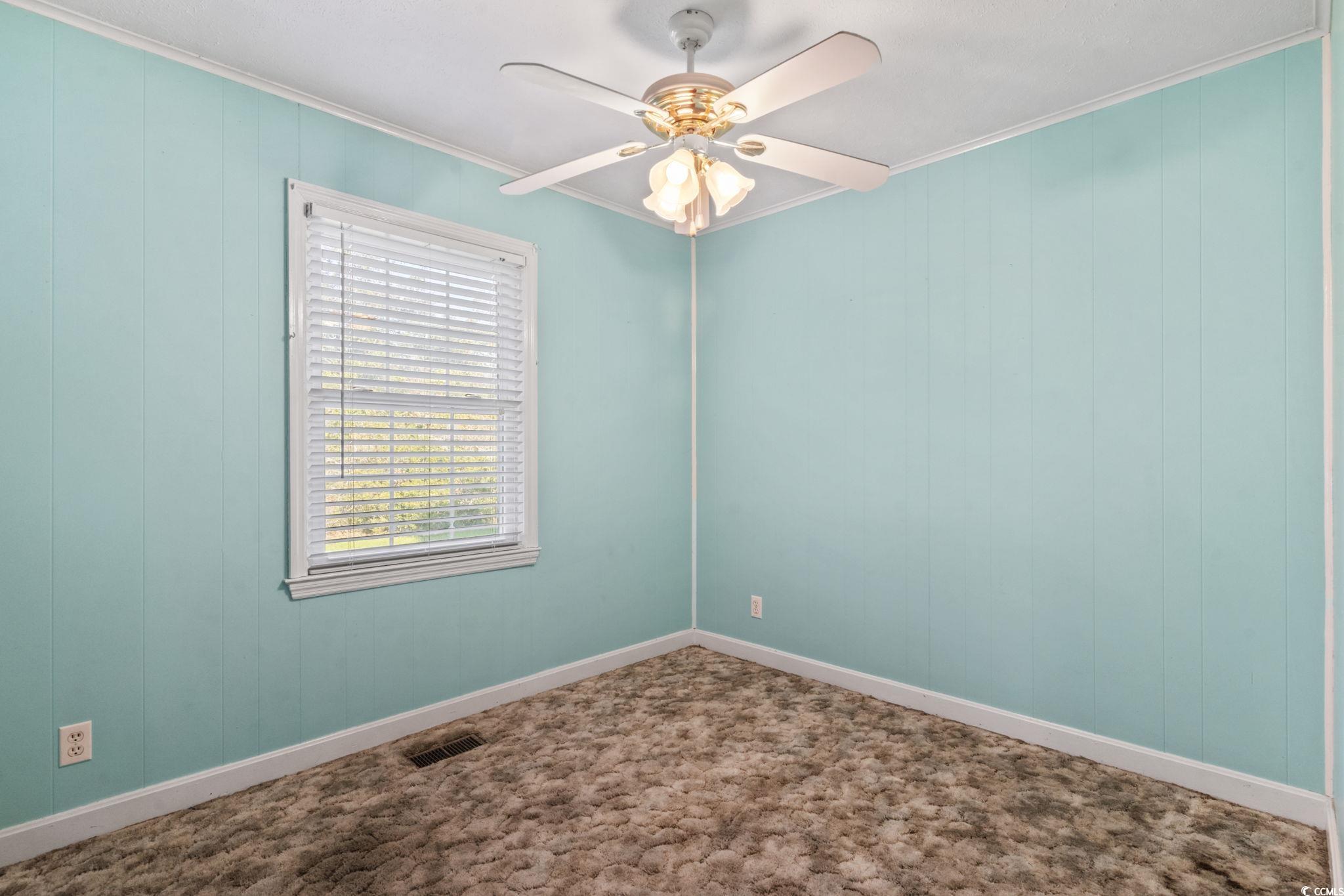 6971 Alfred Road Aynor, SC 29511 - Photo 27 of 37 Spare room featuring crown molding and a ceiling fan