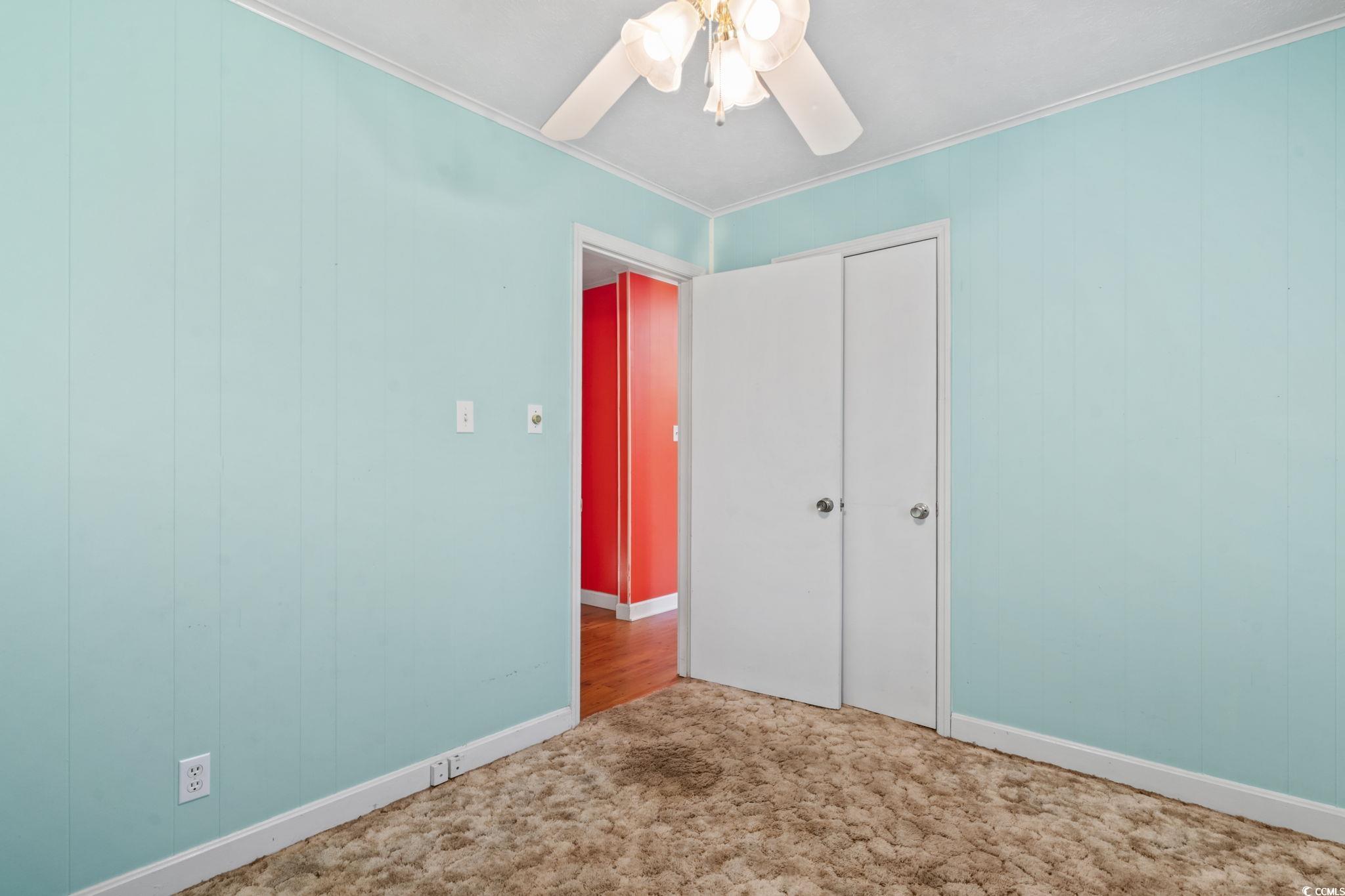 6971 Alfred Road Aynor, SC 29511 - Photo 28 of 37 Unfurnished bedroom with ornamental molding, a ceiling fan, carpet floors, and a closet