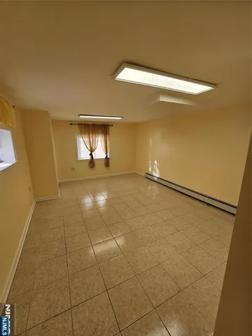 a view of a room with an empty space and a window