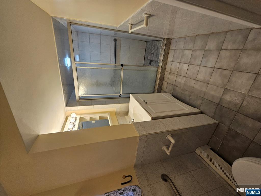 122 Eckel Road Little Ferry, NJ 07643 - Photo 13 of 16 a bathroom with a sink a toilet and shower