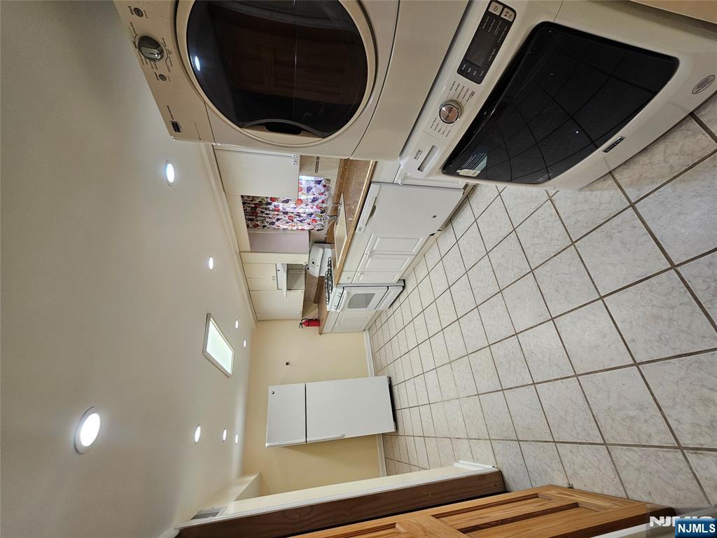 122 Eckel Road Little Ferry, NJ 07643 - Photo 14 of 16 a kitchen with a sink a stove and cabinets