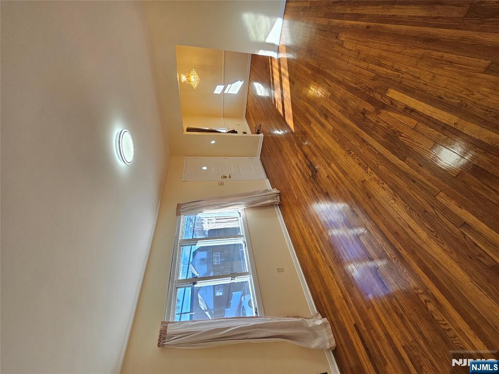 122 Eckel Road Little Ferry, NJ 07643 - Photo 3 of 16 a view of empty room with wooden floor and fan