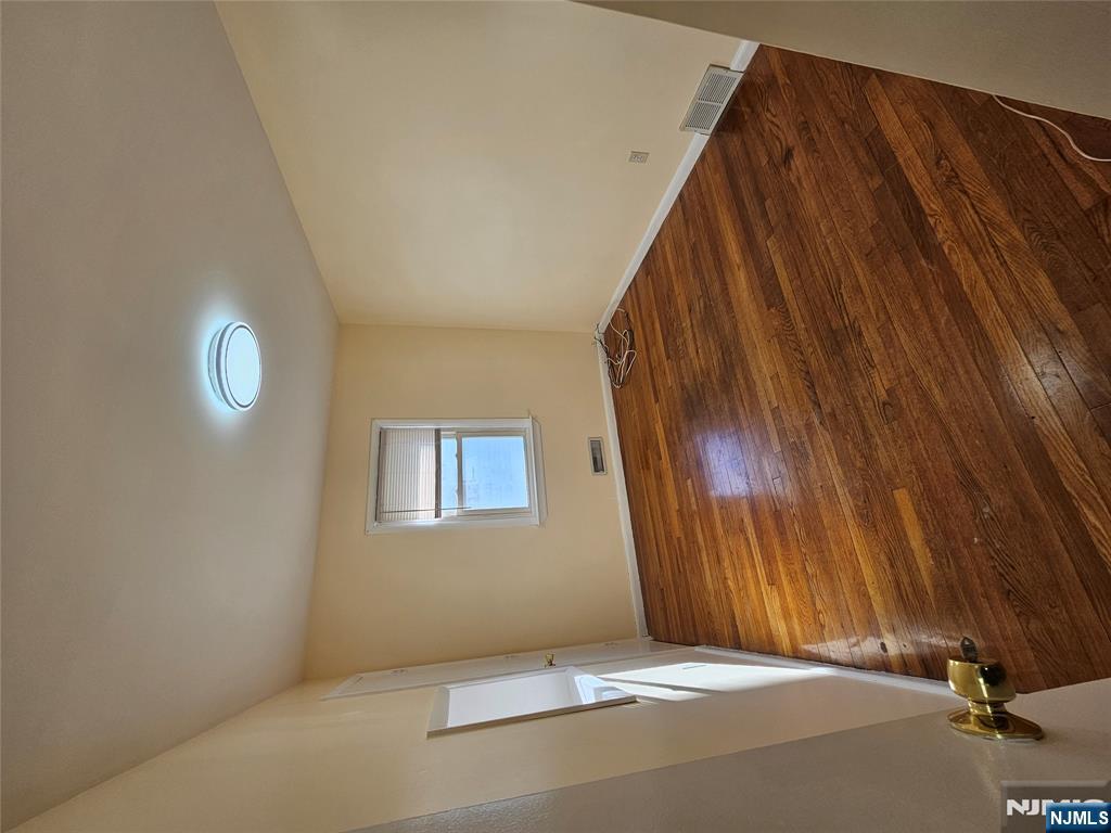 122 Eckel Road Little Ferry, NJ 07643 - Photo 4 of 16 a view of empty room with wooden floor