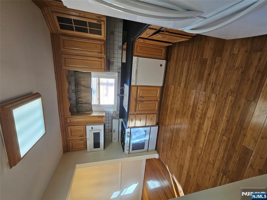 122 Eckel Road Little Ferry, NJ 07643 - Photo 5 of 16 a kitchen with stainless steel appliances granite countertop a sink dishwasher stove and microwave