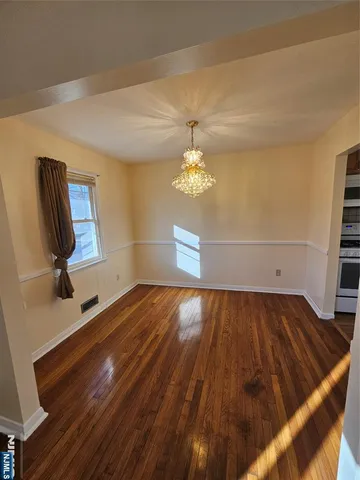 a view of room with wooden floor and workspace
