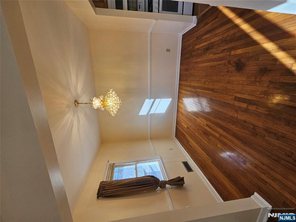 122 Eckel Road Little Ferry, NJ 07643 - Photo 6 of 16 a view of room with wooden floor and workspace