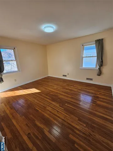 a view of room with wooden floor and window