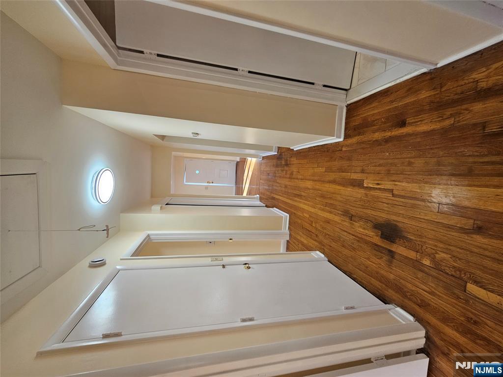 122 Eckel Road Little Ferry, NJ 07643 - Photo 10 of 16 a view of a hallway with wooden floor and staircase