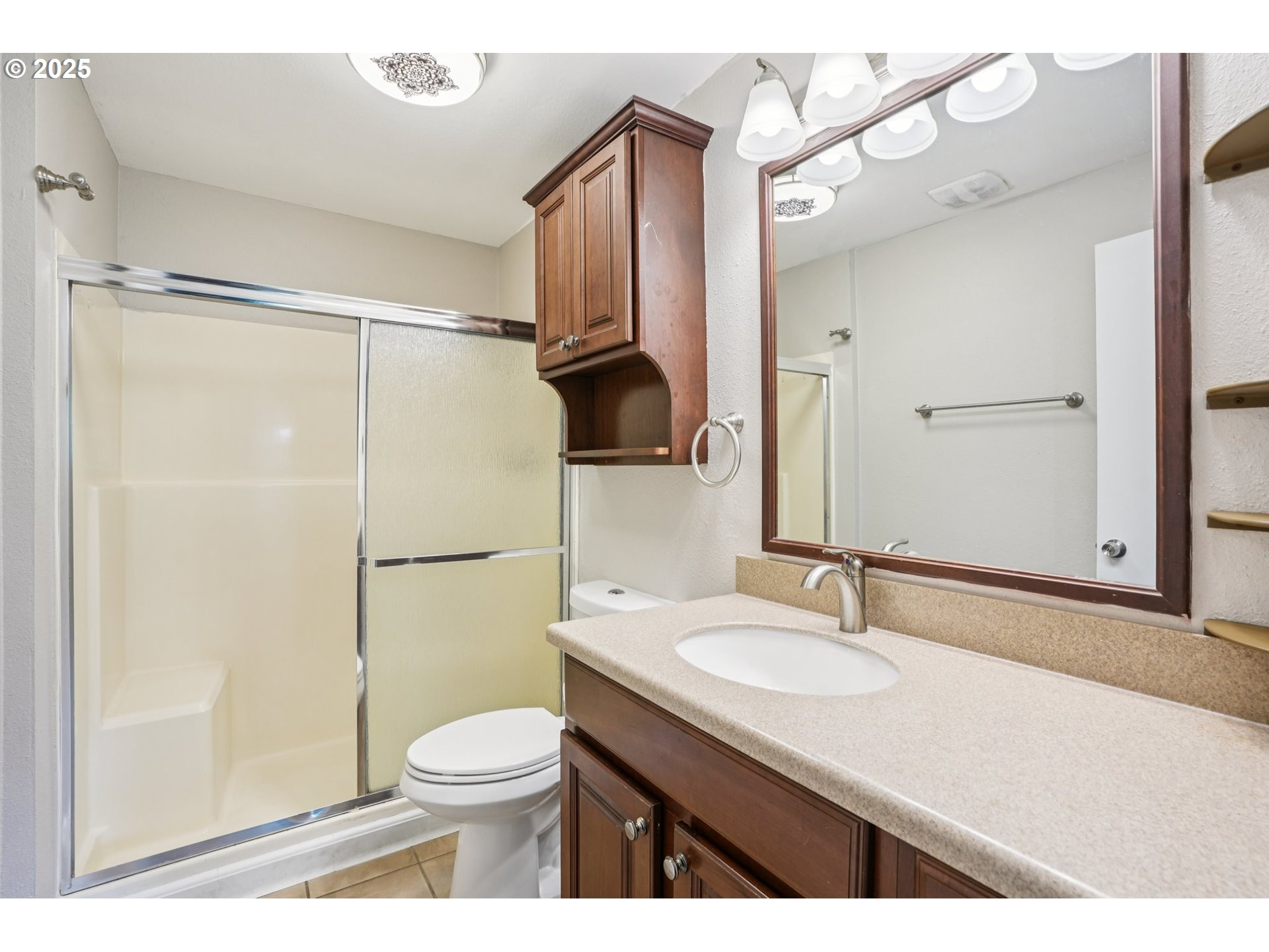9281 Southwest Boones Ferry Road Portland, OR 97219 - Photo 15 of 27 a bathroom with a granite countertop sink toilet and shower