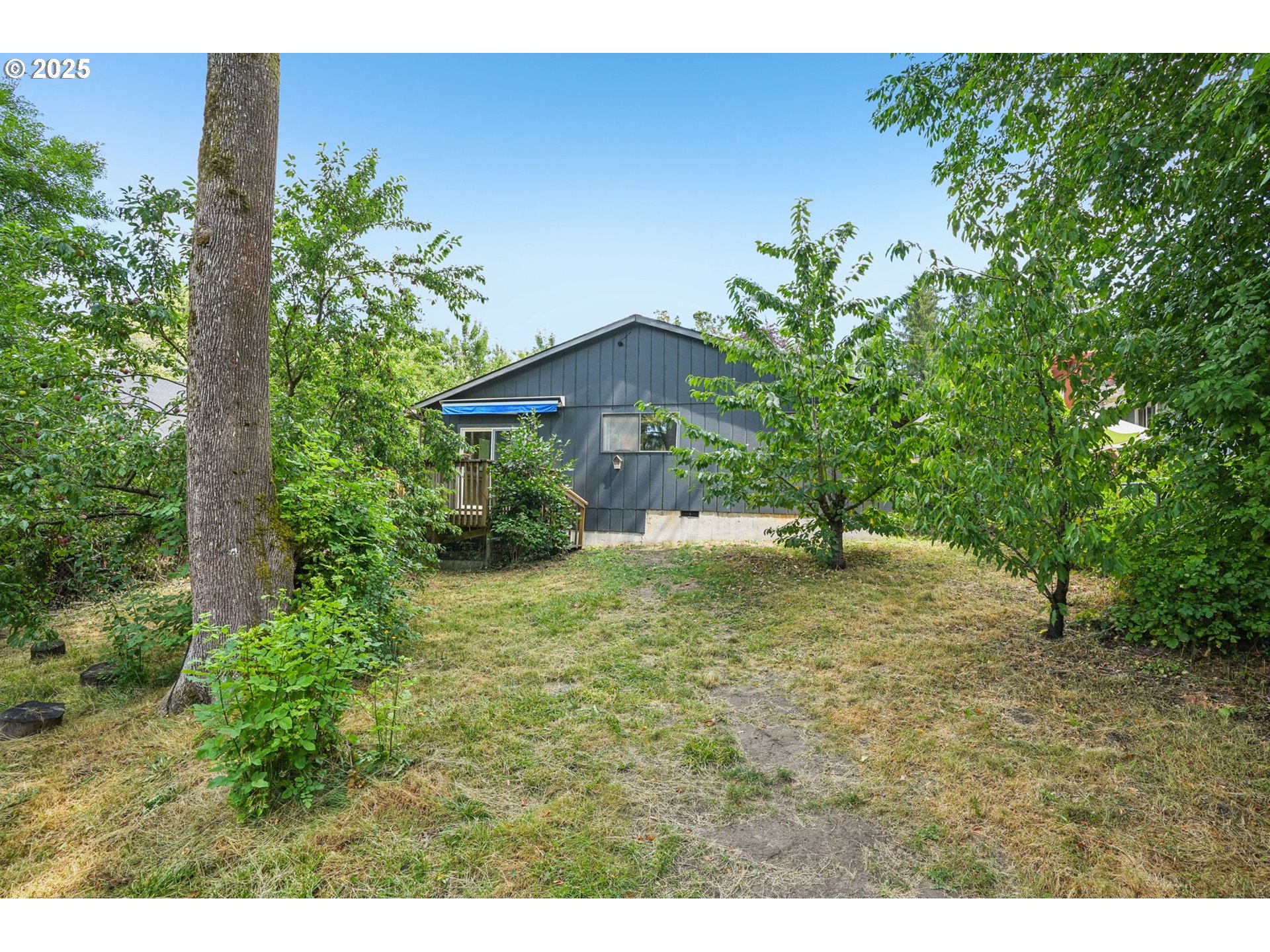 9281 Southwest Boones Ferry Road Portland, OR 97219 - Photo 19 of 27 a view of a house with a yard