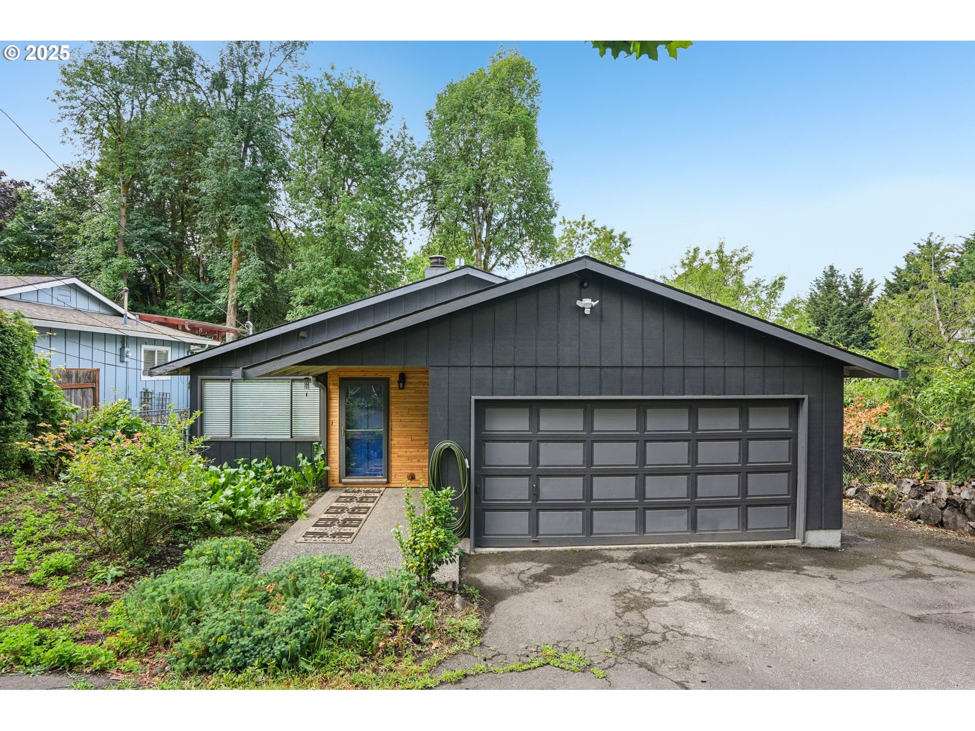 9281 Southwest Boones Ferry Road Portland, OR 97219 - Photo 2 of 27 a view of a small house with a yard