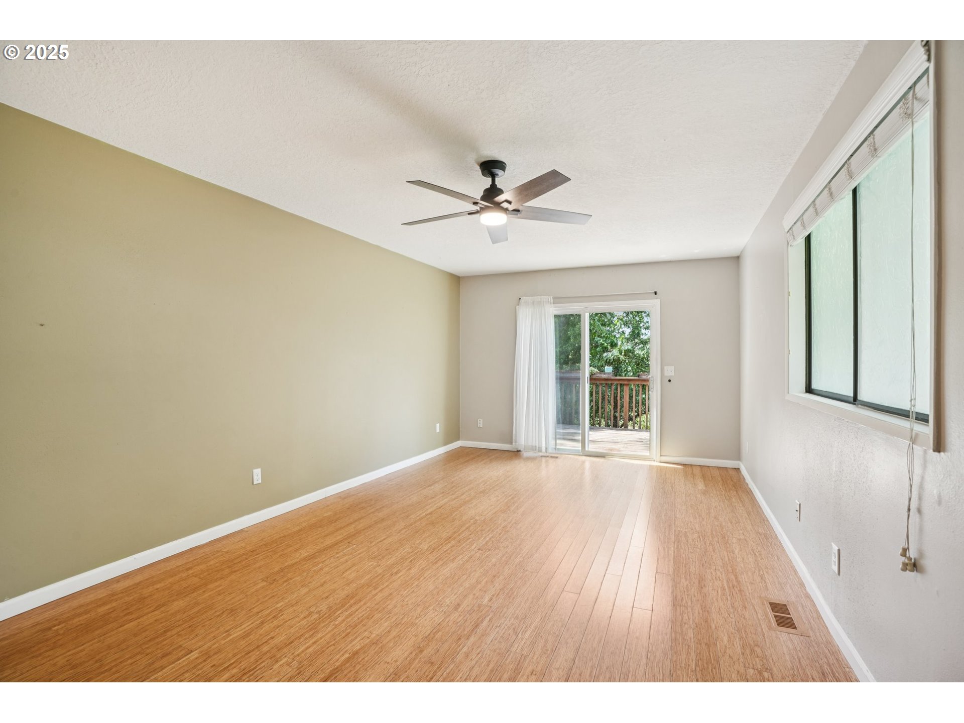 9281 Southwest Boones Ferry Road Portland, OR 97219 - Photo 9 of 27 a view of an empty room with a window and wooden floor