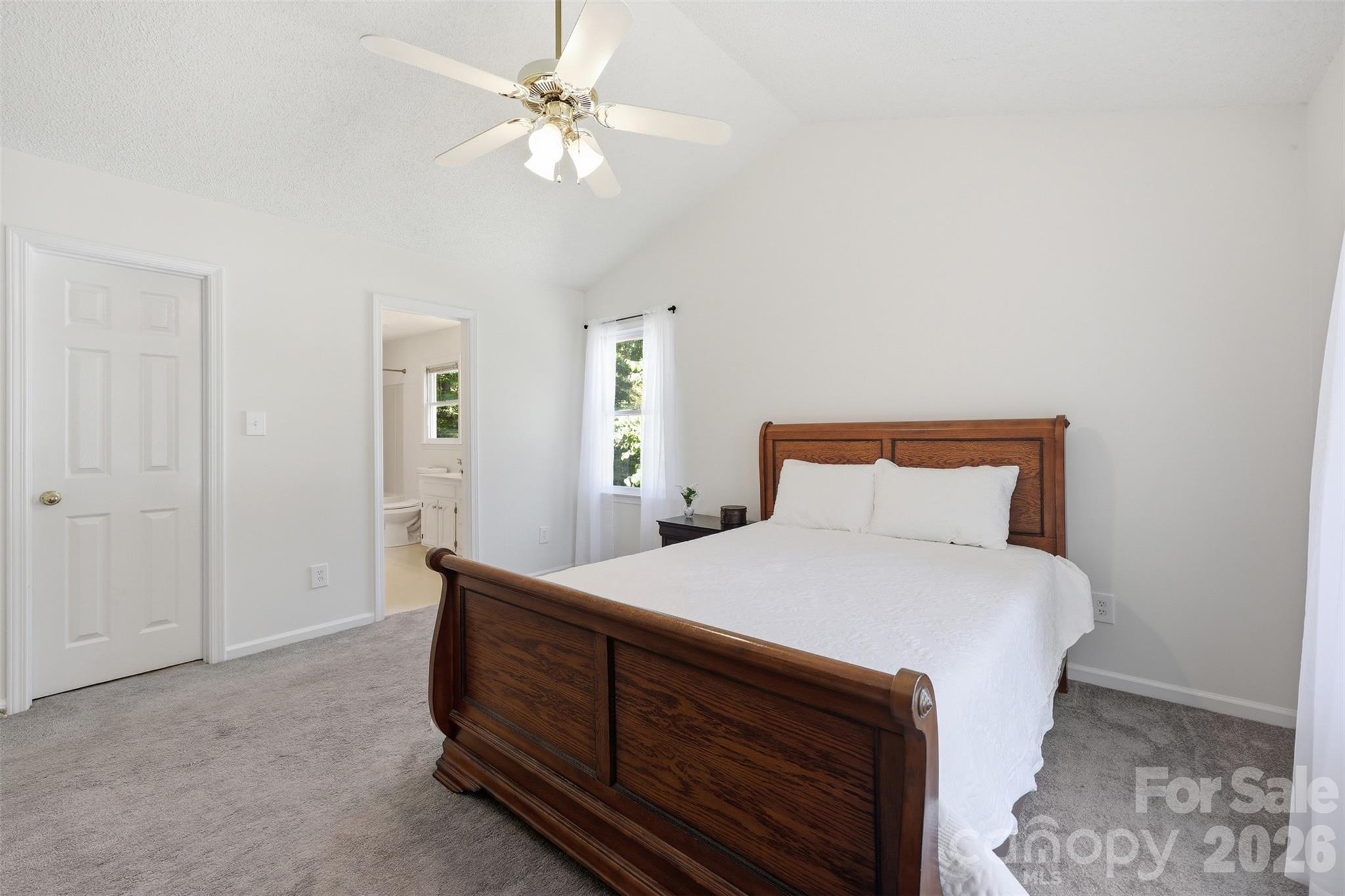 913 Pleasant Ridge Road Fort Mill, SC 29715 - Photo 15 of 40 a bedroom with a bed and a chandelier