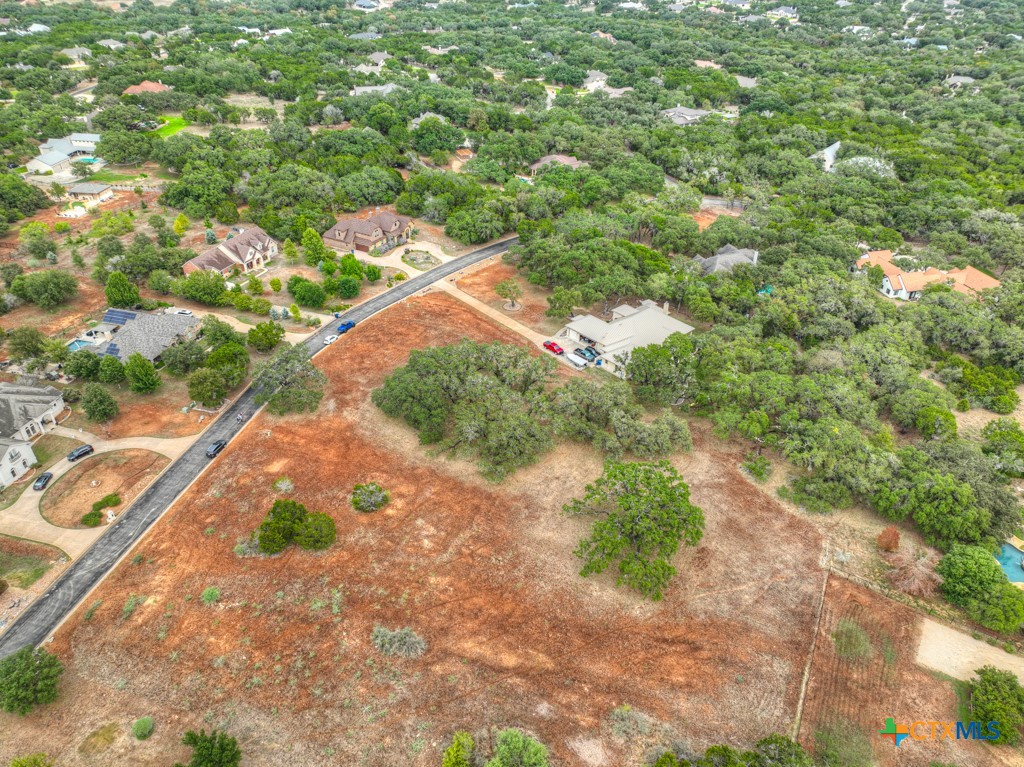 27215 Park Loop Road New Braunfels, TX 78132 - Photo 9 of 32 a backyard of a house with a yard and outdoor seating