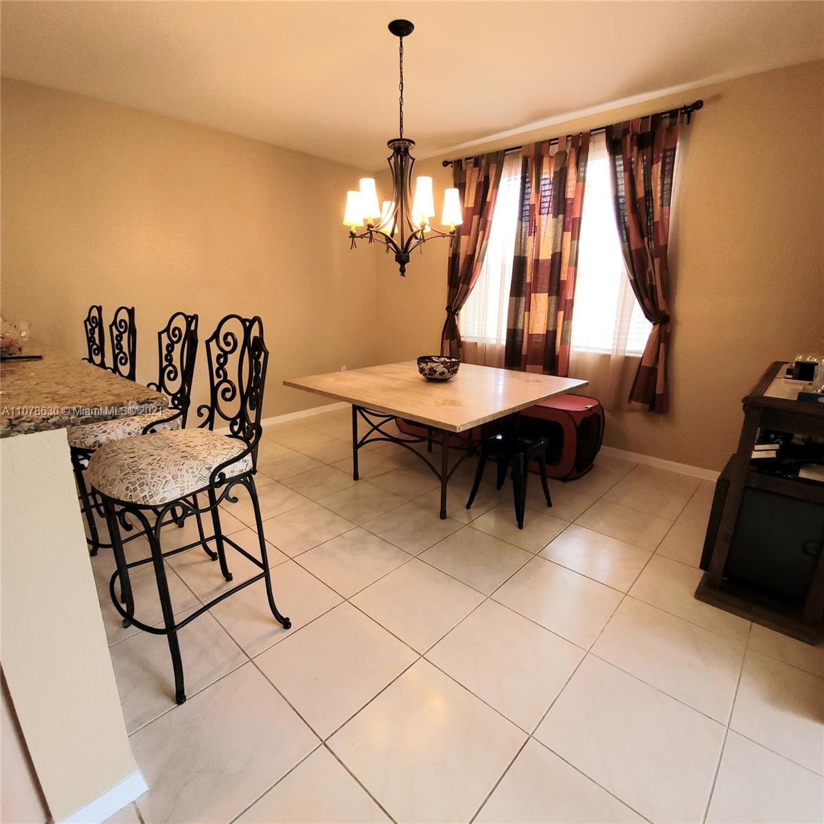 Keys Gate Homestead, FL 33035 - Photo 11 of 26 a view of a dining room with furniture and window