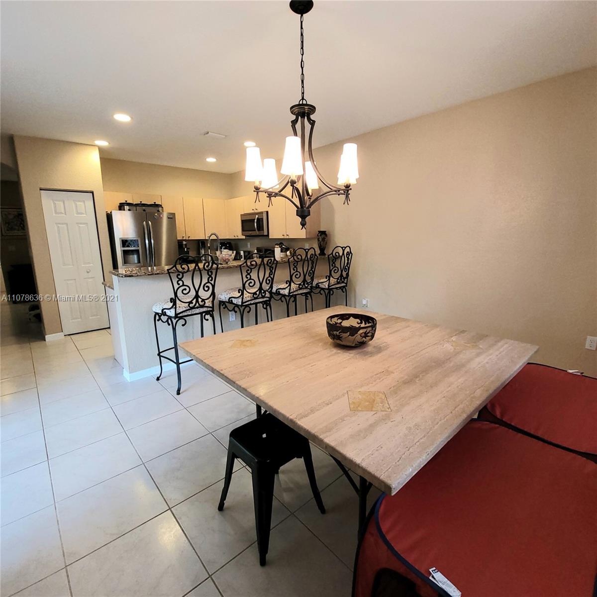 Keys Gate Homestead, FL 33035 - Photo 12 of 26 a view of a dining room with furniture and chandelier
