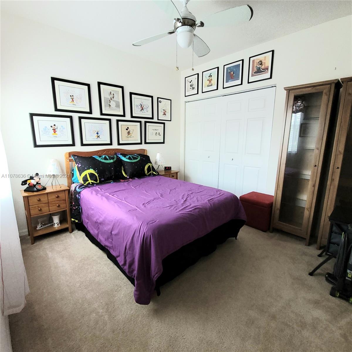 Keys Gate Homestead, FL 33035 - Photo 16 of 26 a bedroom with a bed a dresser and book shelf