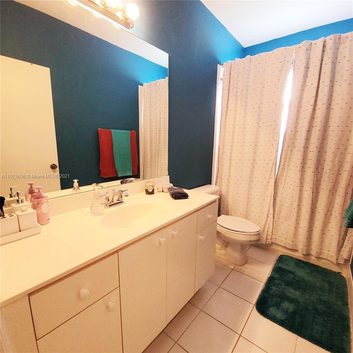 Keys Gate Homestead, FL 33035 - Photo 17 of 26 a bathroom with a sink and a mirror