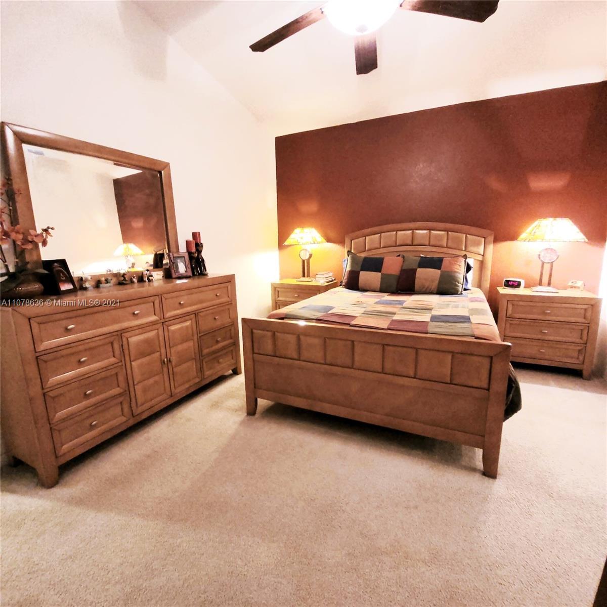 Keys Gate Homestead, FL 33035 - Photo 20 of 26 a bedroom with a bed dresser and a large mirror