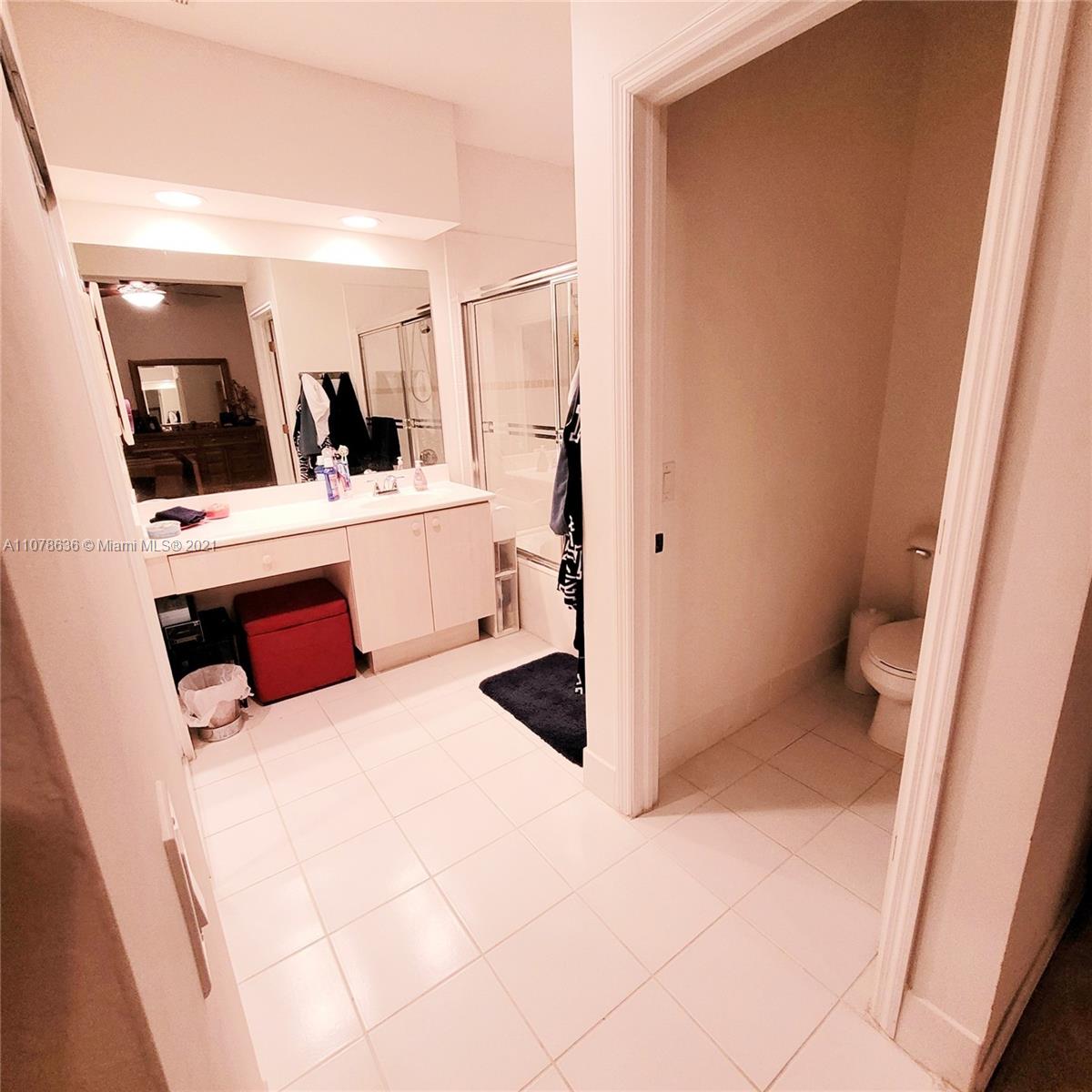 Keys Gate Homestead, FL 33035 - Photo 22 of 26 a bathroom with a sink a mirror and shower