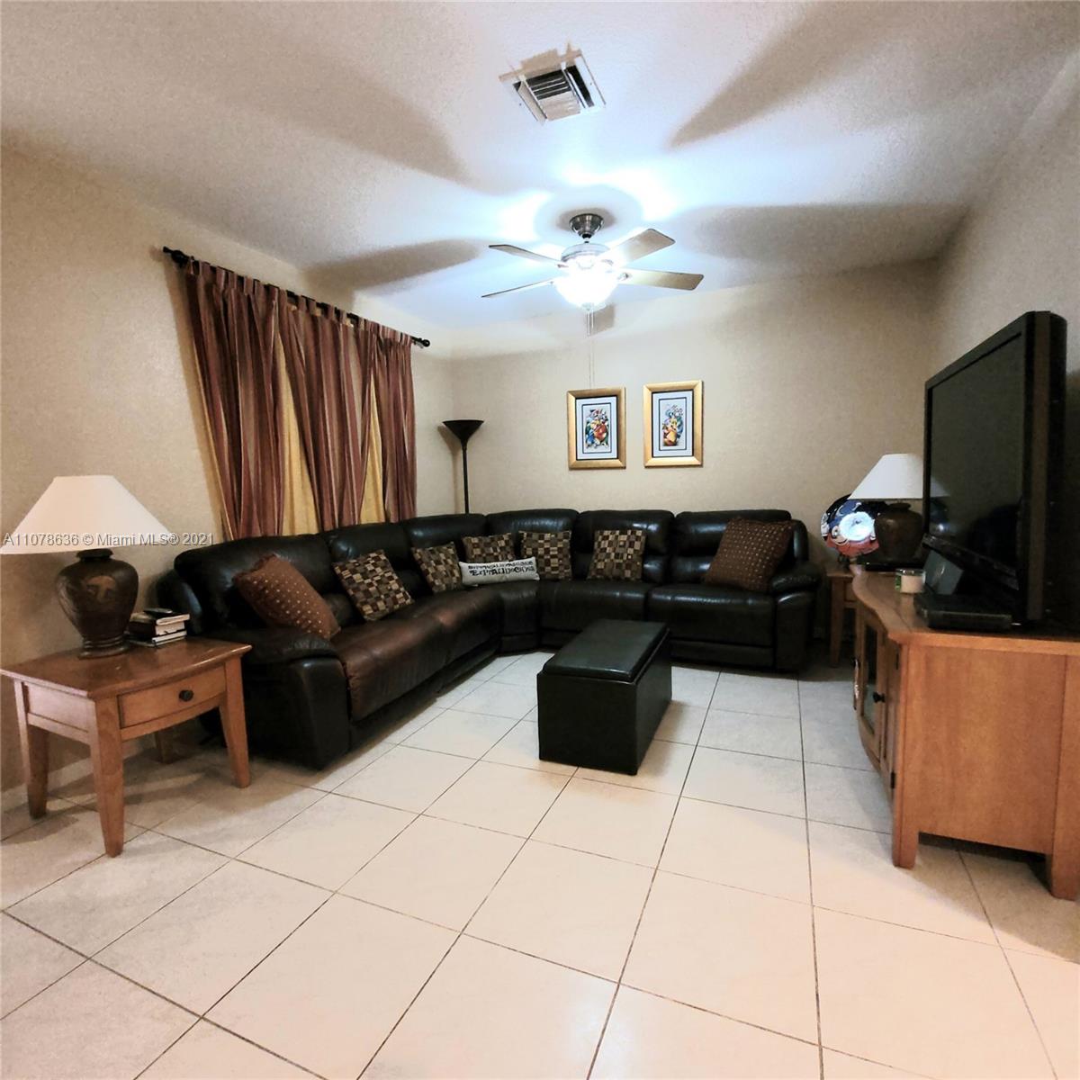 Keys Gate Homestead, FL 33035 - Photo 7 of 26 a living room with furniture and a flat screen tv