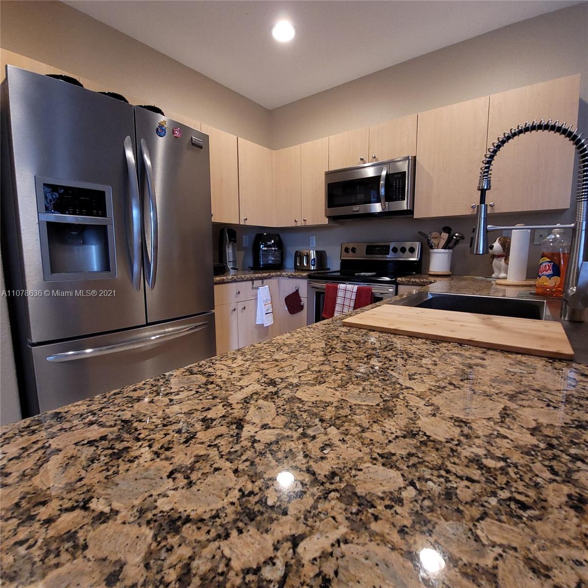 Keys Gate Homestead, FL 33035 - Photo 9 of 26 a kitchen with granite countertop a refrigerator and a sink