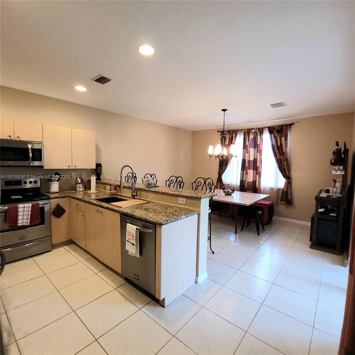 Keys Gate Homestead, FL 33035 - Photo 10 of 26 a kitchen with sink refrigerator and stove