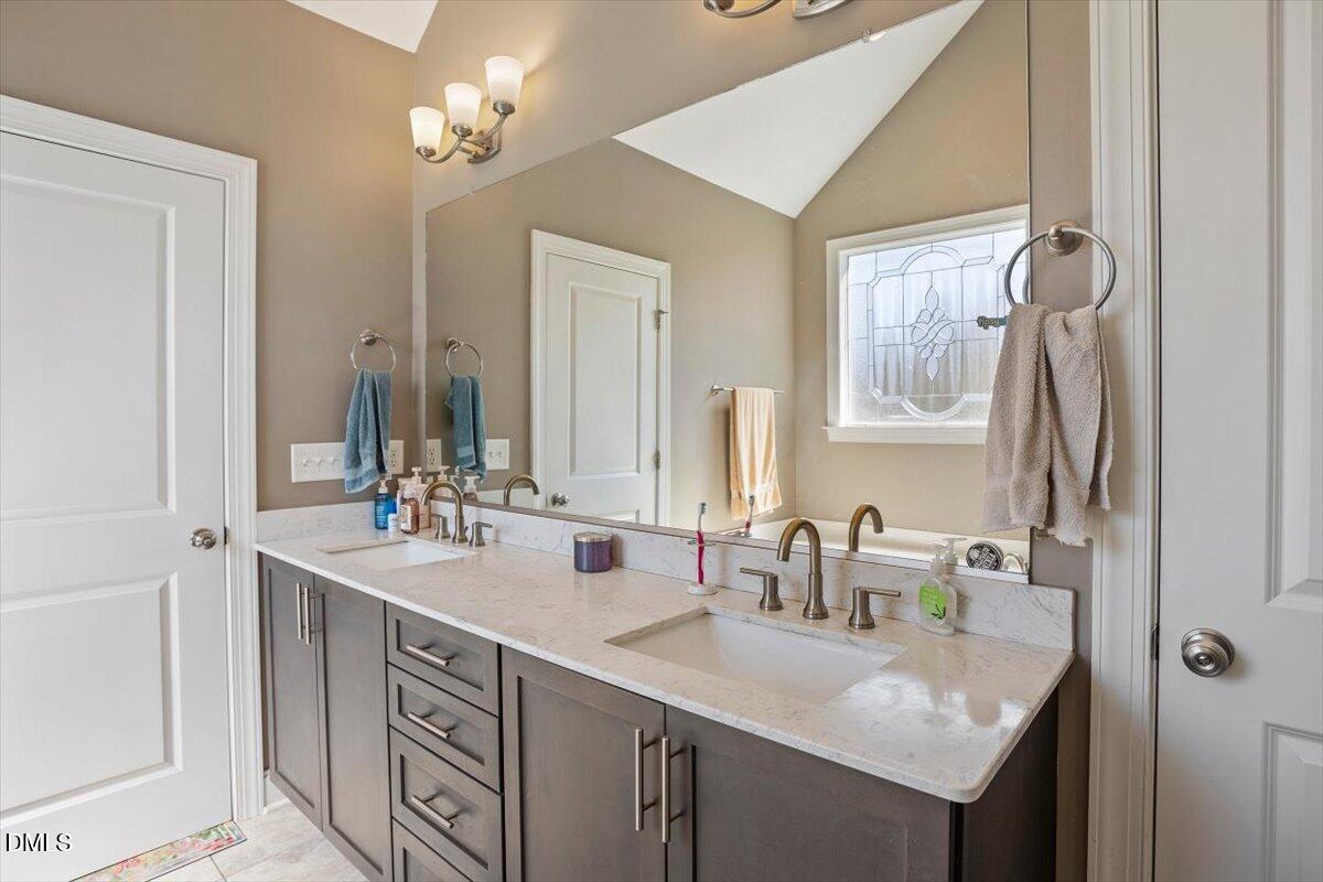 1001 Bellewood Farms Road Raleigh, NC 27603 - Photo 29 of 39 a bathroom with double vanity and a mirror
