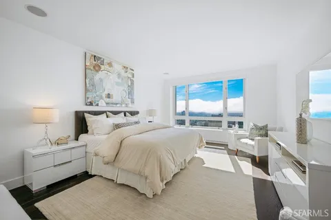 a bedroom with a bed and a large mirror