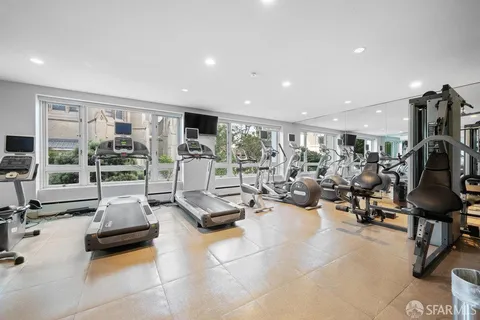 a room with table chairs and wooden walls