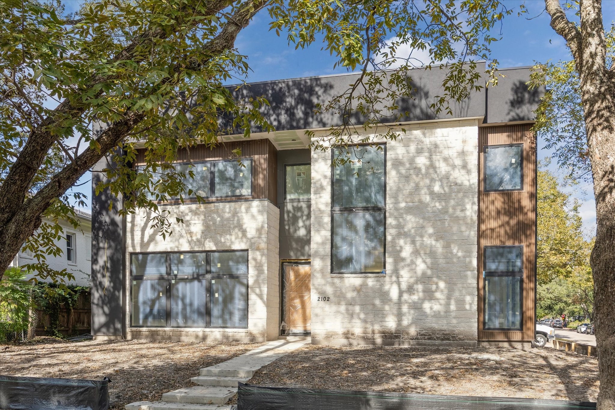a view of a house with a tree next to a yard