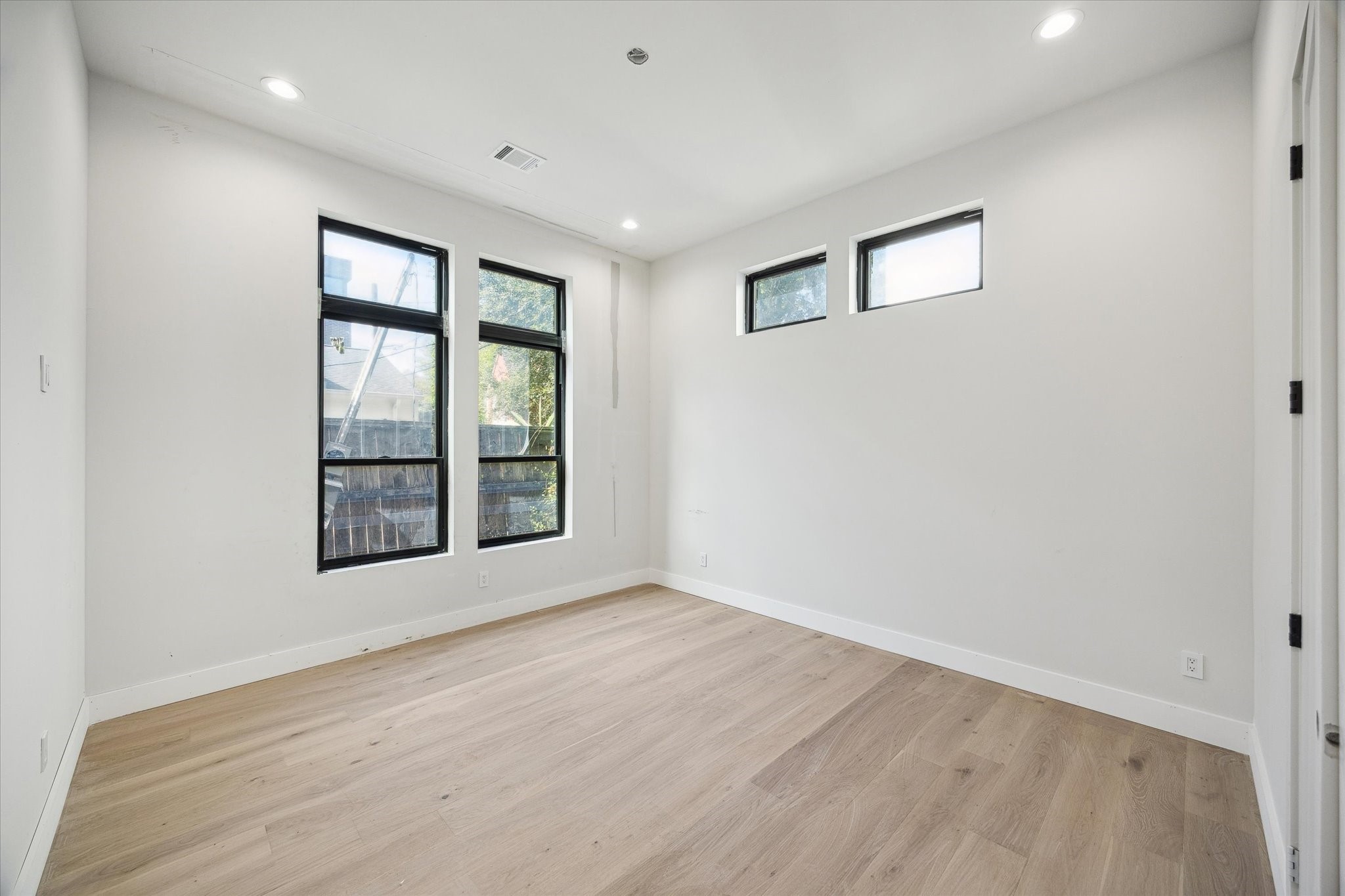 2102 Tangley Street Houston, TX 77005 - Photo 13 of 30 a view of an empty room with a window and wooden floor