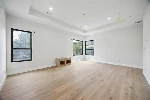 wooden floor in an empty room with a window