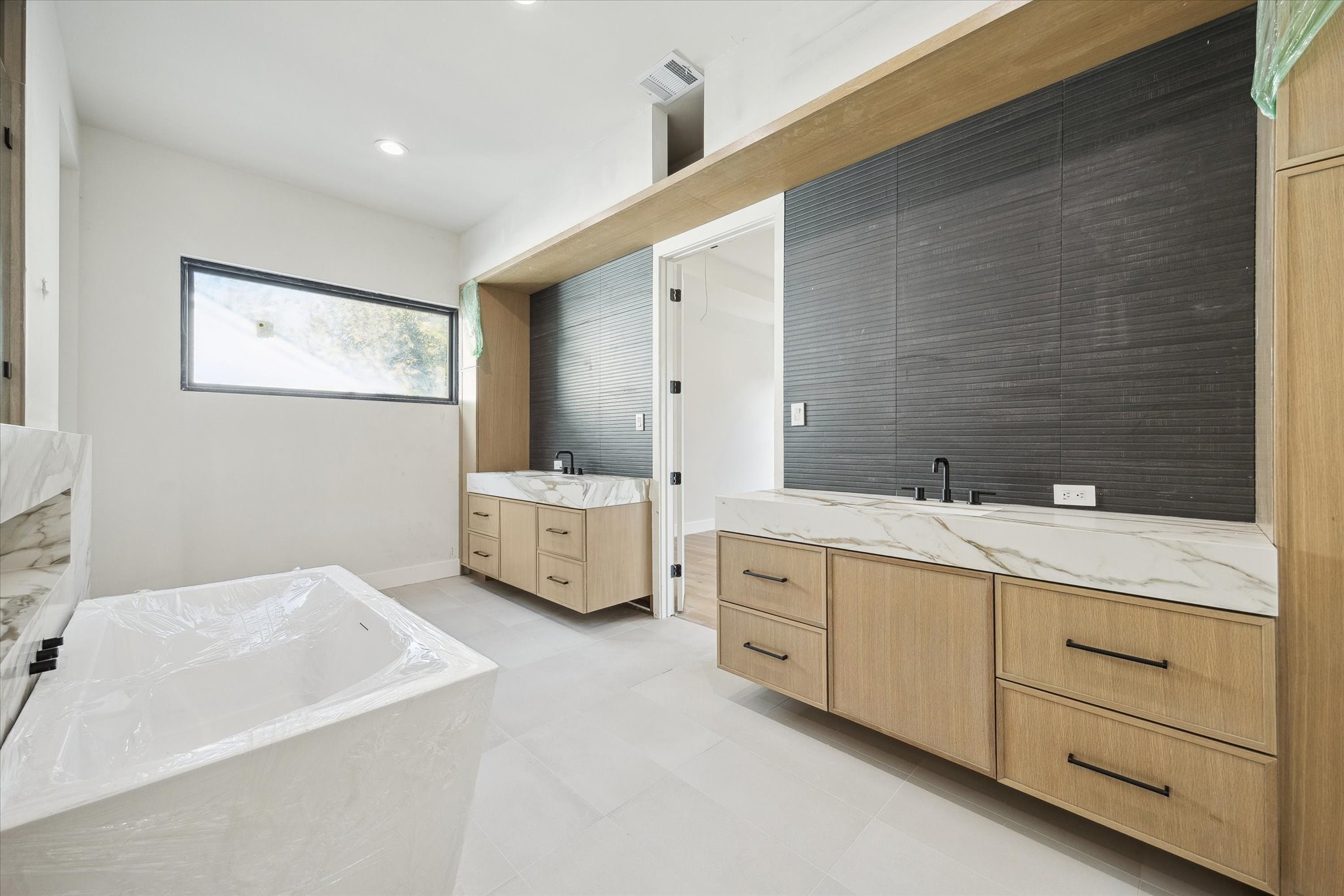 2102 Tangley Street Houston, TX 77005 - Photo 19 of 30 a bathroom with double vanity sink a mirror and a bathtub